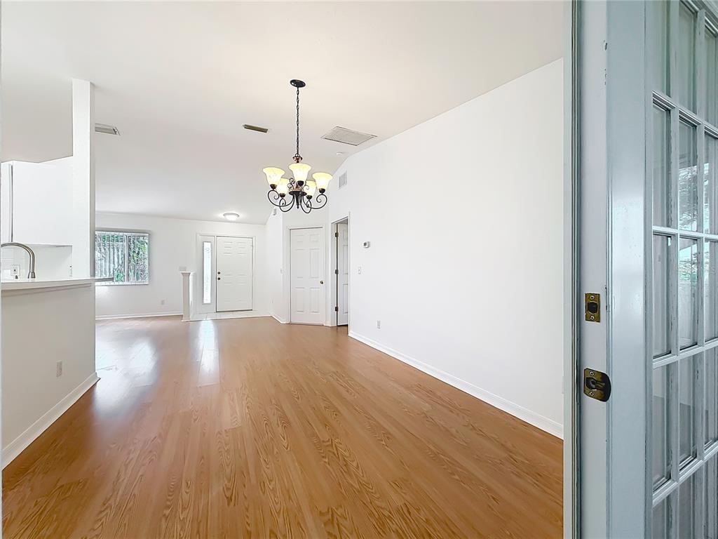 6175 Southwest 98th Loop Ocala, FL 34476 - Photo 14 of 56 a view of a room with wooden floor chandelier and entryway