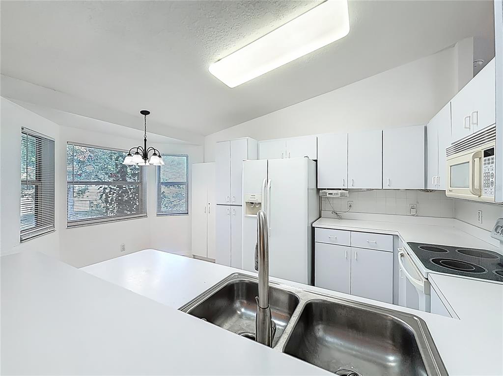 6175 Southwest 98th Loop Ocala, FL 34476 - Photo 15 of 56 a kitchen that has a sink cabinets counter space and appliances