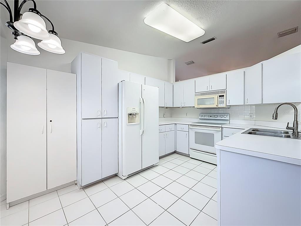 6175 Southwest 98th Loop Ocala, FL 34476 - Photo 16 of 56 a kitchen with white cabinets and white appliances
