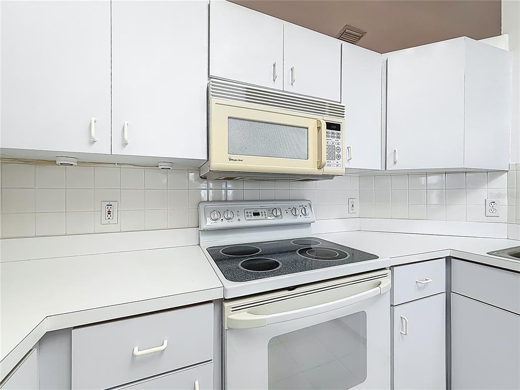 6175 Southwest 98th Loop Ocala, FL 34476 - Photo 20 of 56 a kitchen with granite countertop white cabinets and white appliances