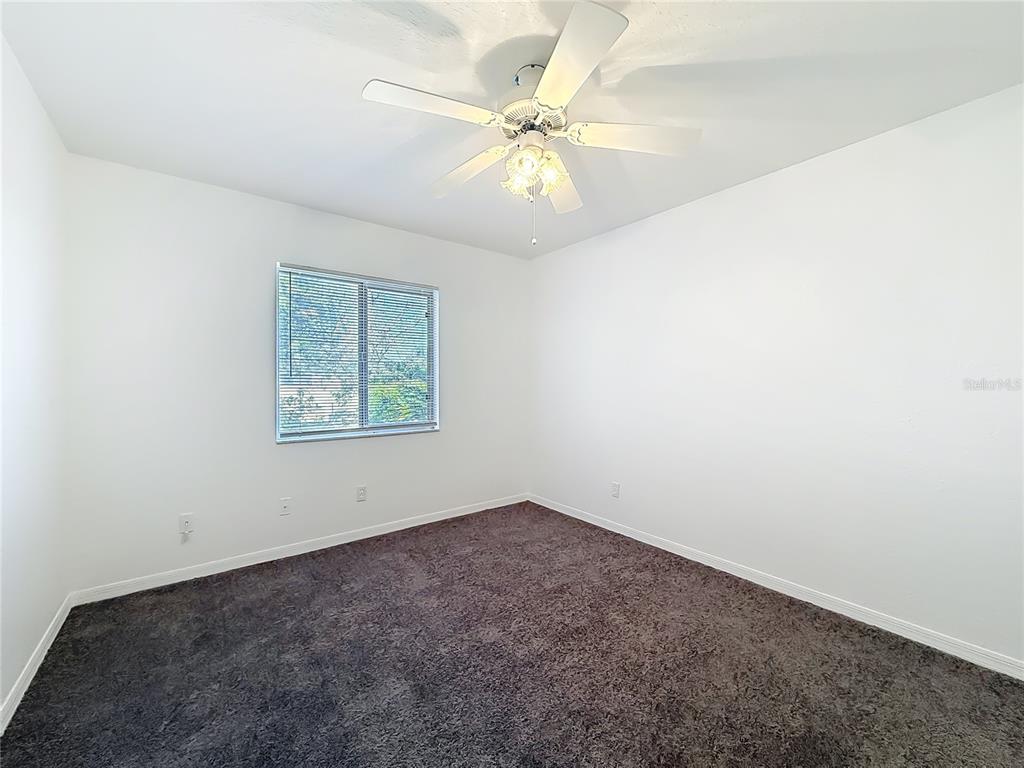 6175 Southwest 98th Loop Ocala, FL 34476 - Photo 22 of 56 an empty room with a window and a fan