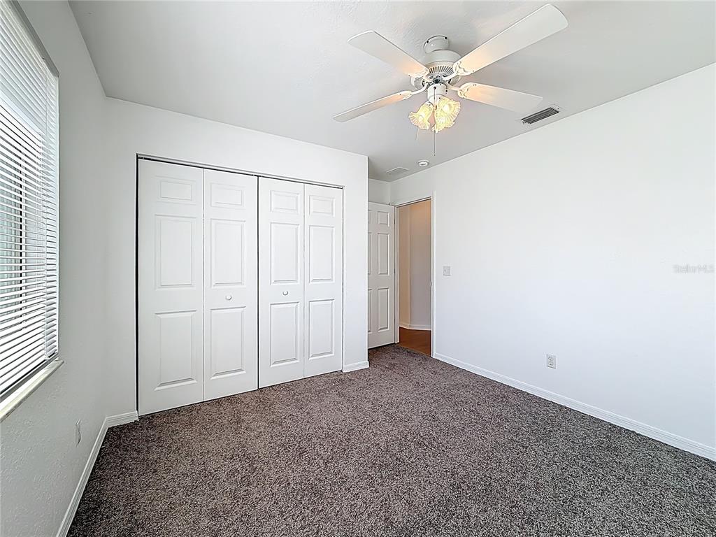 6175 Southwest 98th Loop Ocala, FL 34476 - Photo 27 of 56 an empty room with fan and windows