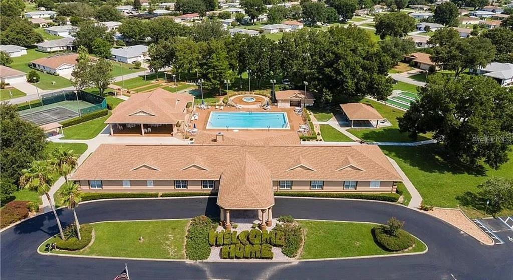 6175 Southwest 98th Loop Ocala, FL 34476 - Photo 3 of 56 an aerial view of a house with a garden and lake view