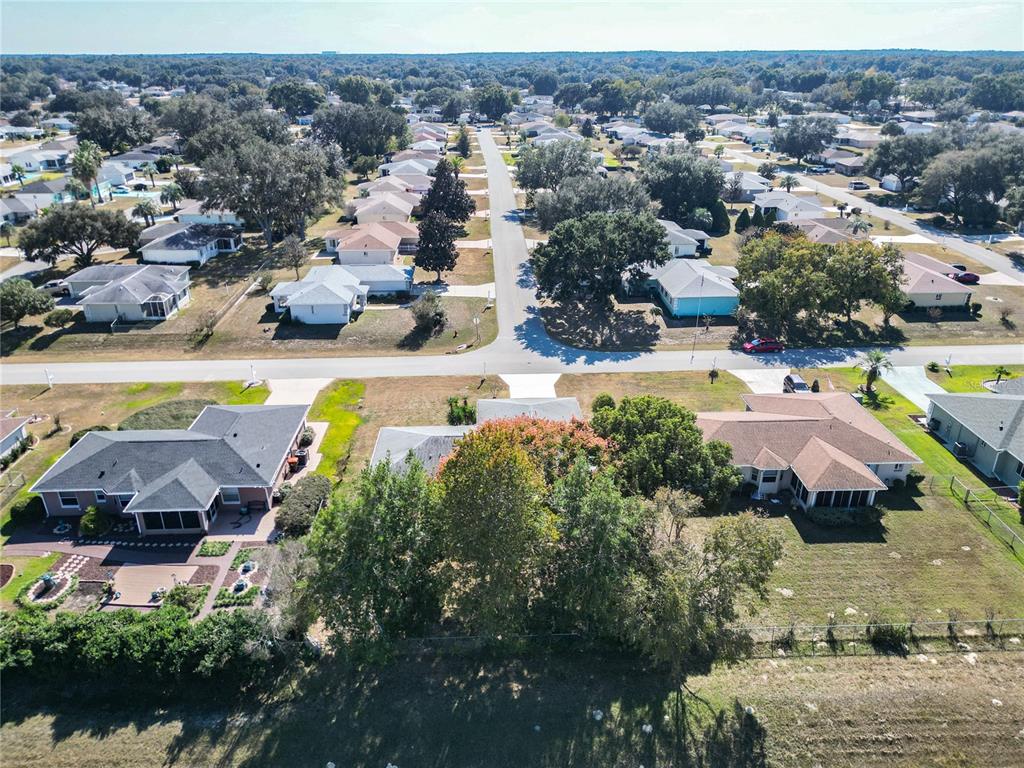 6175 Southwest 98th Loop Ocala, FL 34476 - Photo 52 of 56 an aerial view of a house with a swimming pool yard and outdoor seating