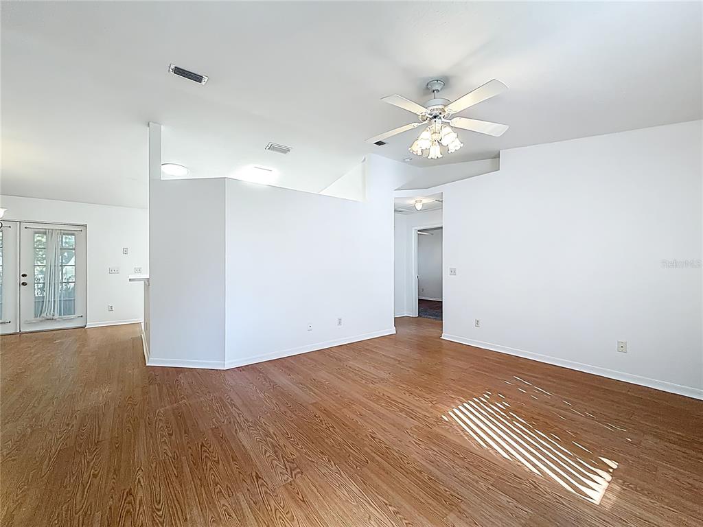 6175 Southwest 98th Loop Ocala, FL 34476 - Photo 9 of 56 a view of an empty room with window and wooden floor