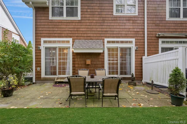 a view of a house with backyard and sitting area