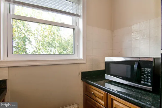 a living room with a fireplace and a floor to ceiling window