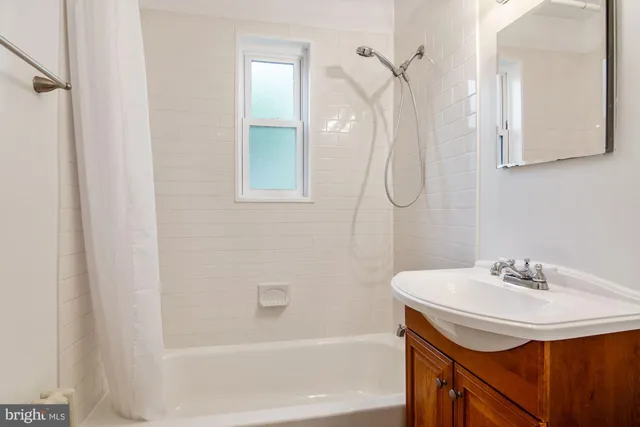 a bathroom with a sink a mirror and a bathtub