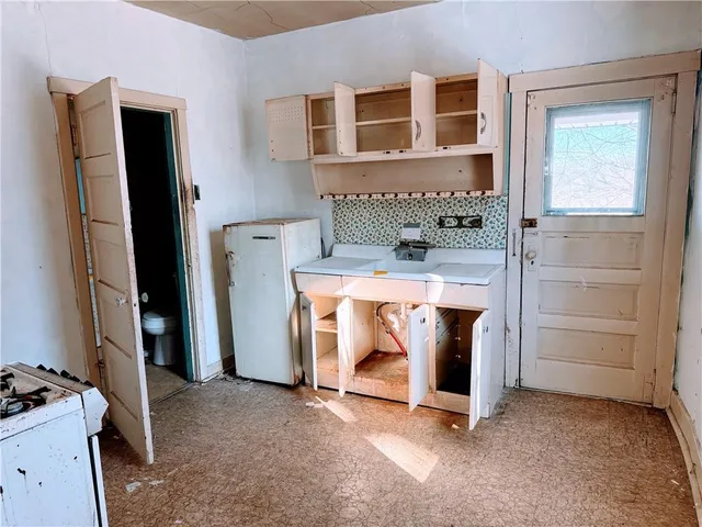 a view of an empty room with a fireplace