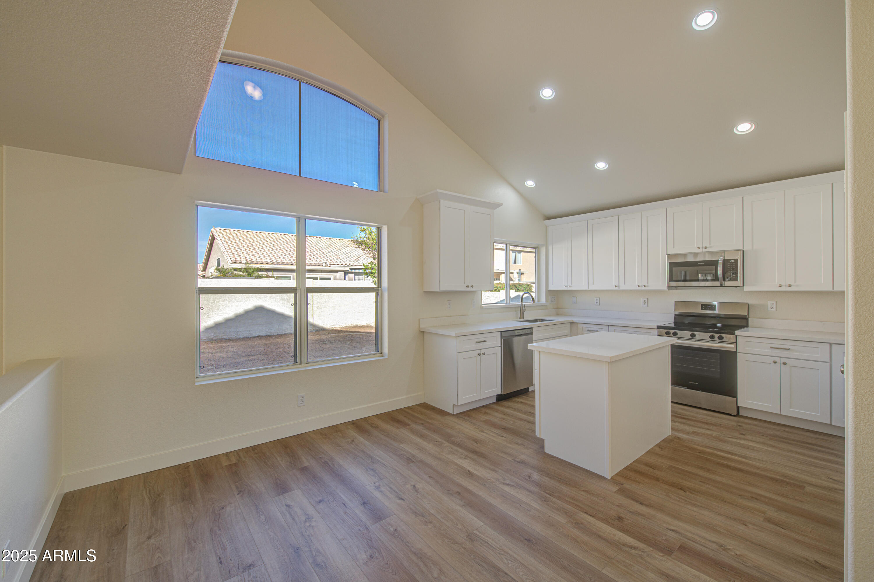 4266 East Millbrae Lane Gilbert, AZ 85234 - Photo 13 of 53 a kitchen with a white cabinets wooden floor and a sink