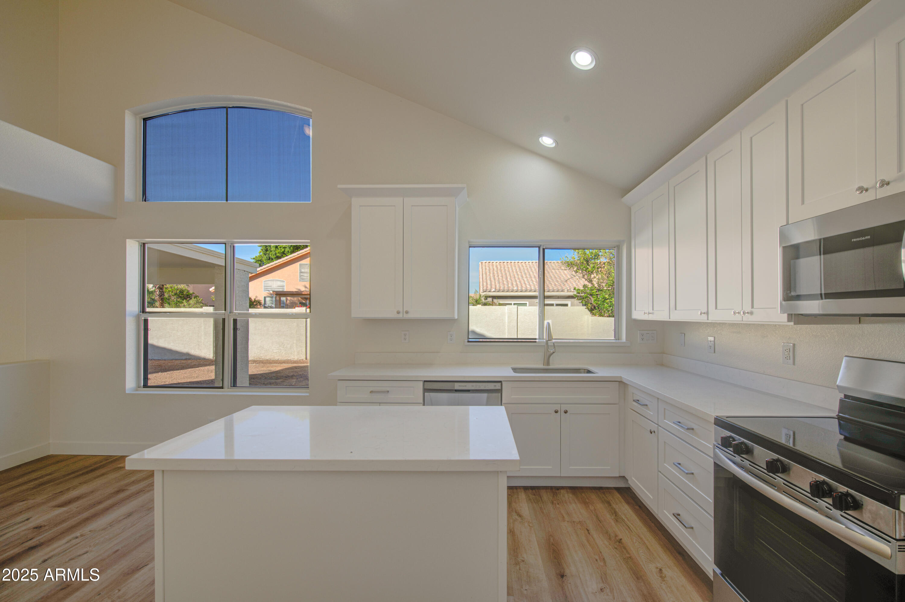 4266 East Millbrae Lane Gilbert, AZ 85234 - Photo 19 of 53 a kitchen with a sink a stove a microwave and cabinets