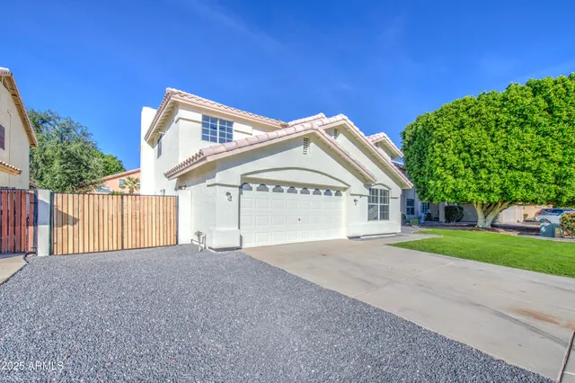 a view of a house with a yard and garage