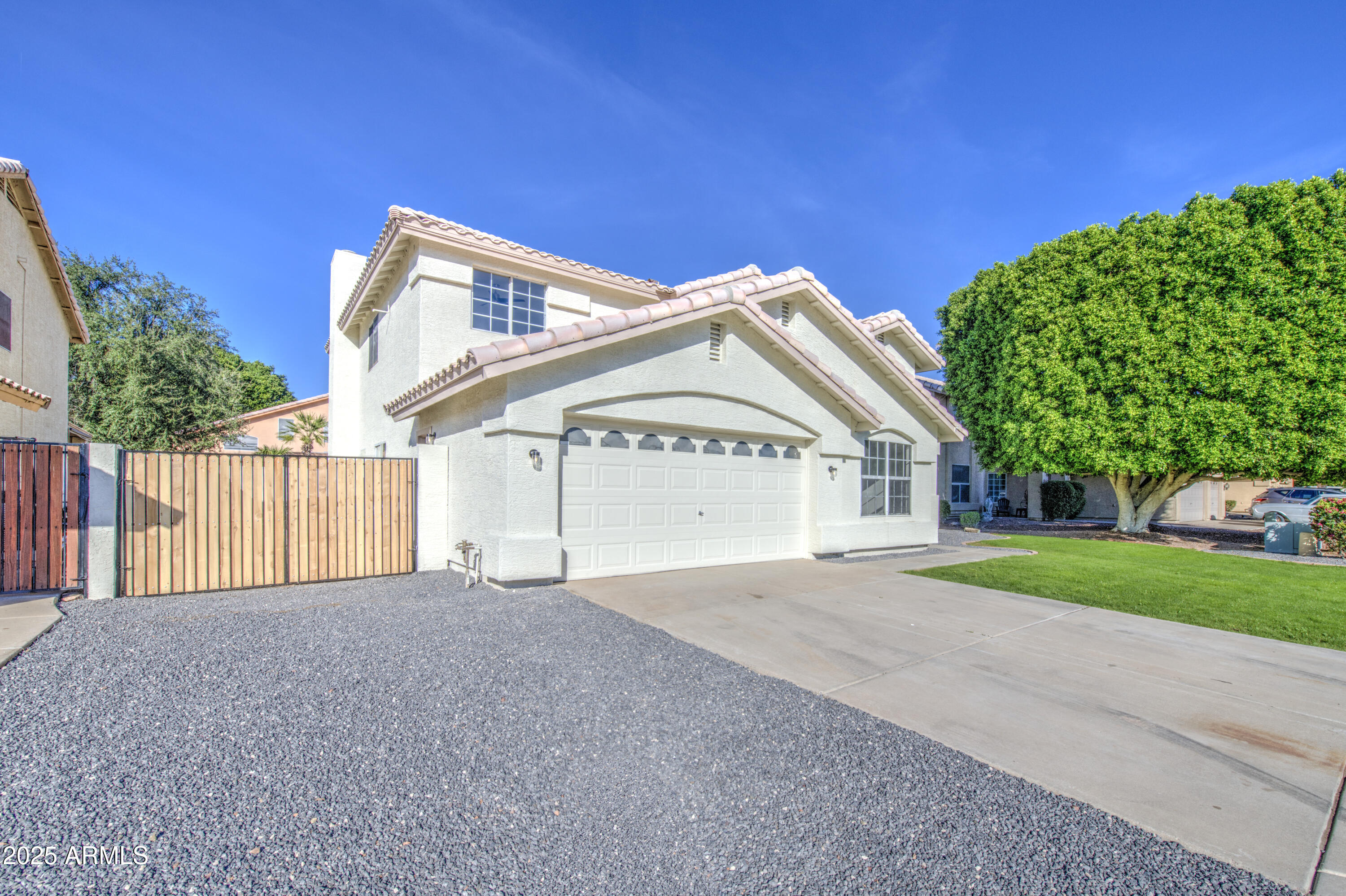 4266 East Millbrae Lane Gilbert, AZ 85234 - Photo 2 of 53 a view of a house with a yard and garage