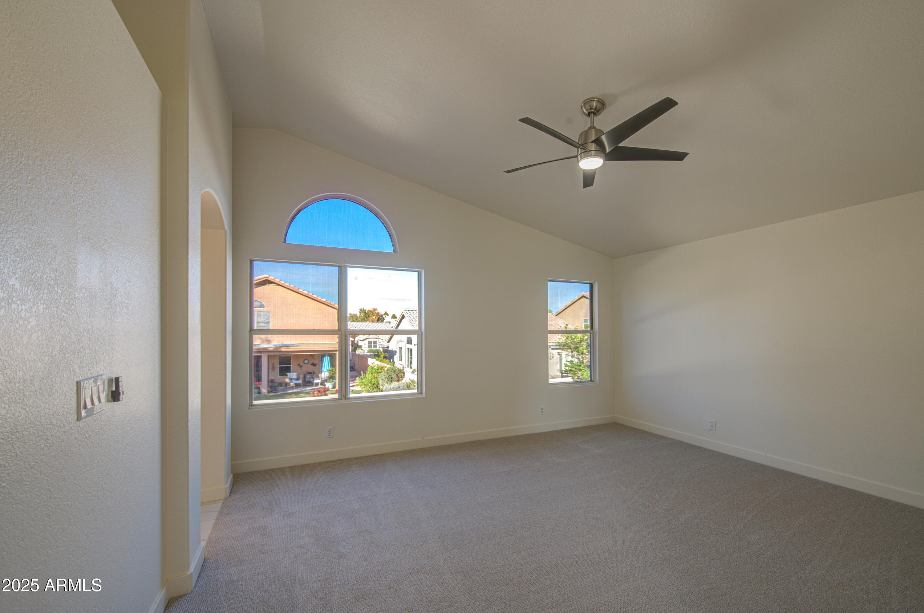4266 East Millbrae Lane Gilbert, AZ 85234 - Photo 22 of 53 a view of an empty room with window and chandelier fan