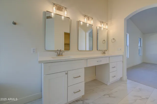 a bathroom with a bathtub a sink and a mirror