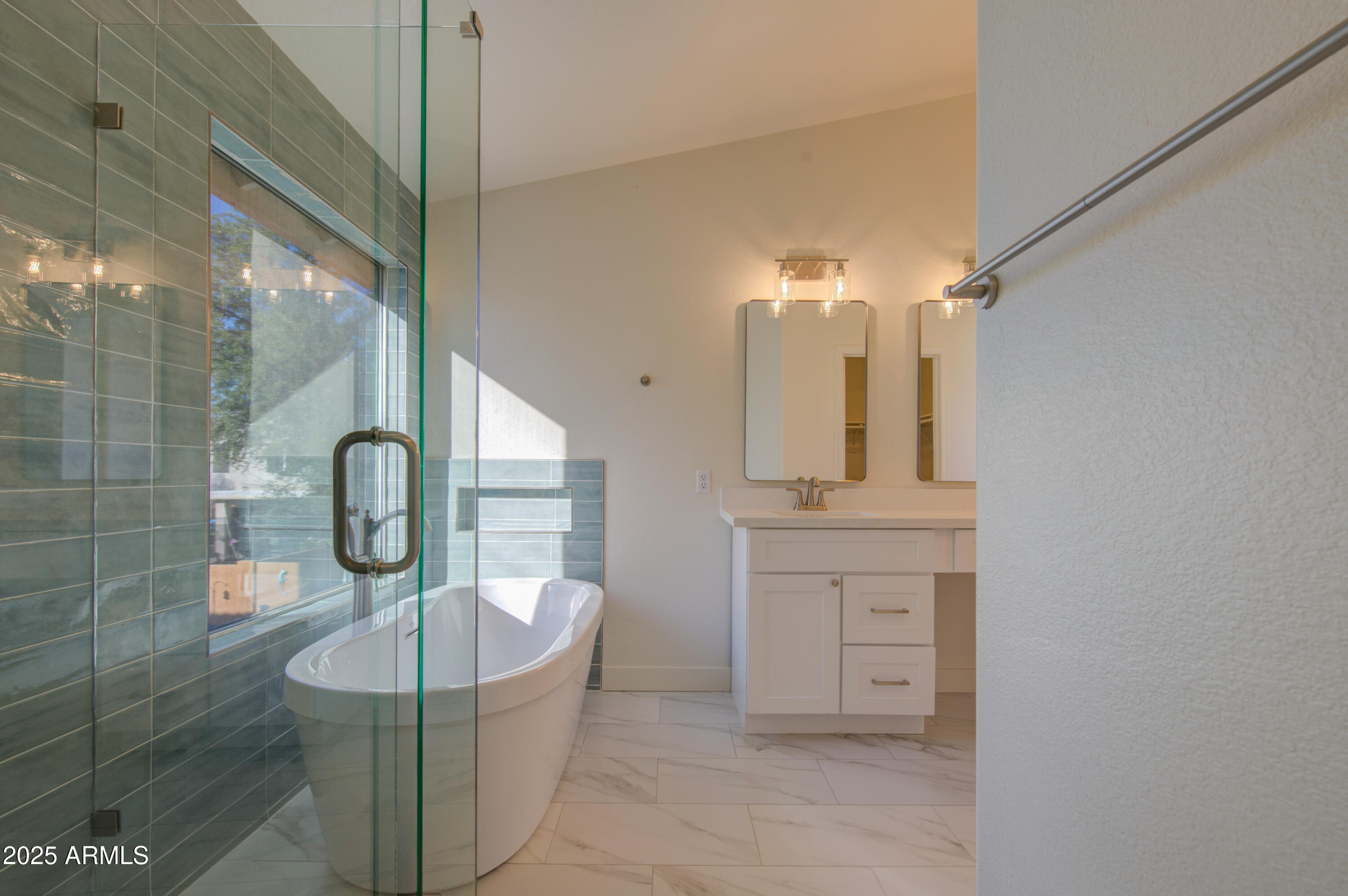 4266 East Millbrae Lane Gilbert, AZ 85234 - Photo 31 of 53 a bathroom with a bathtub a sink and a mirror