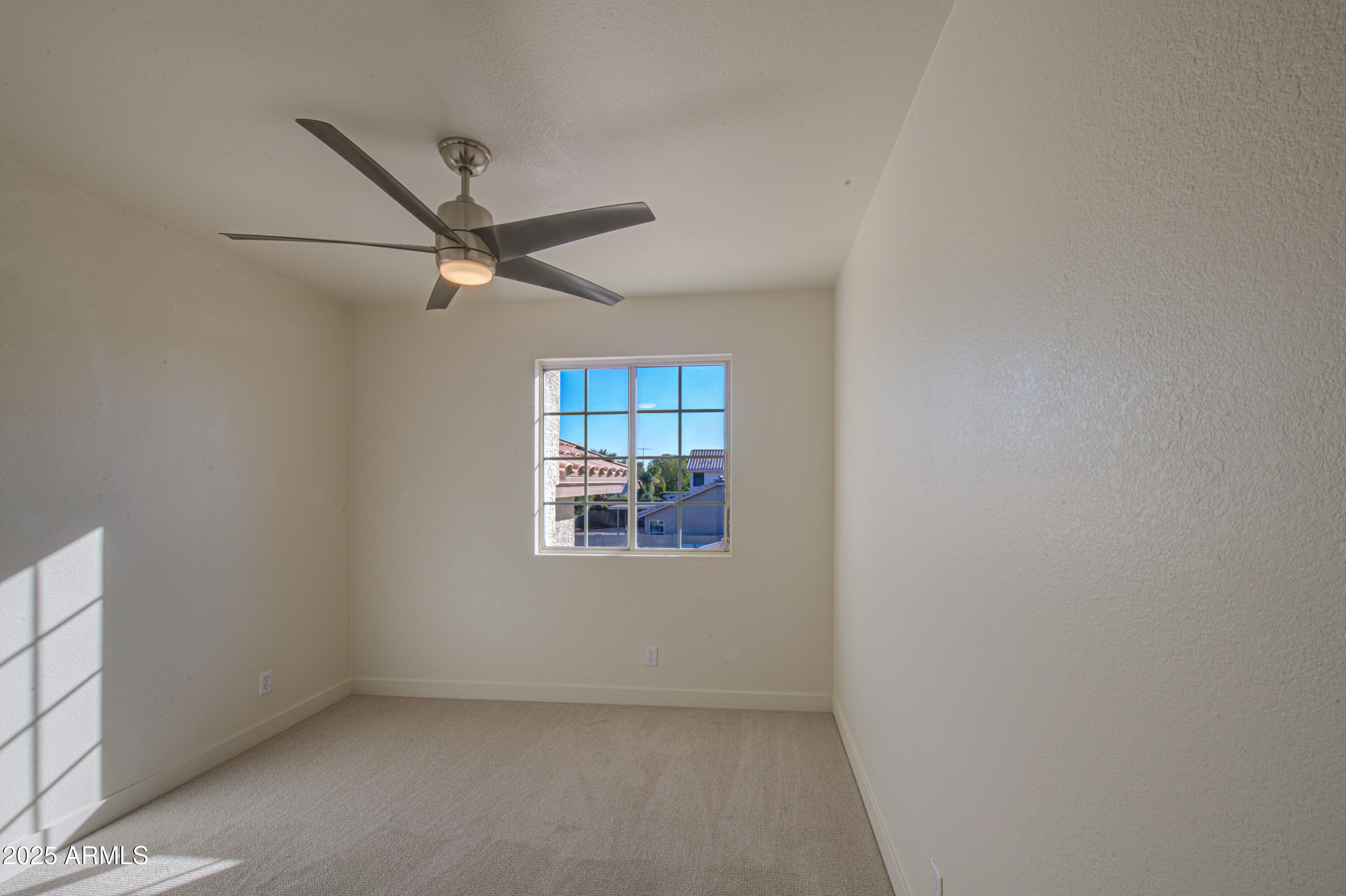 4266 East Millbrae Lane Gilbert, AZ 85234 - Photo 36 of 53 an empty room with windows and fan