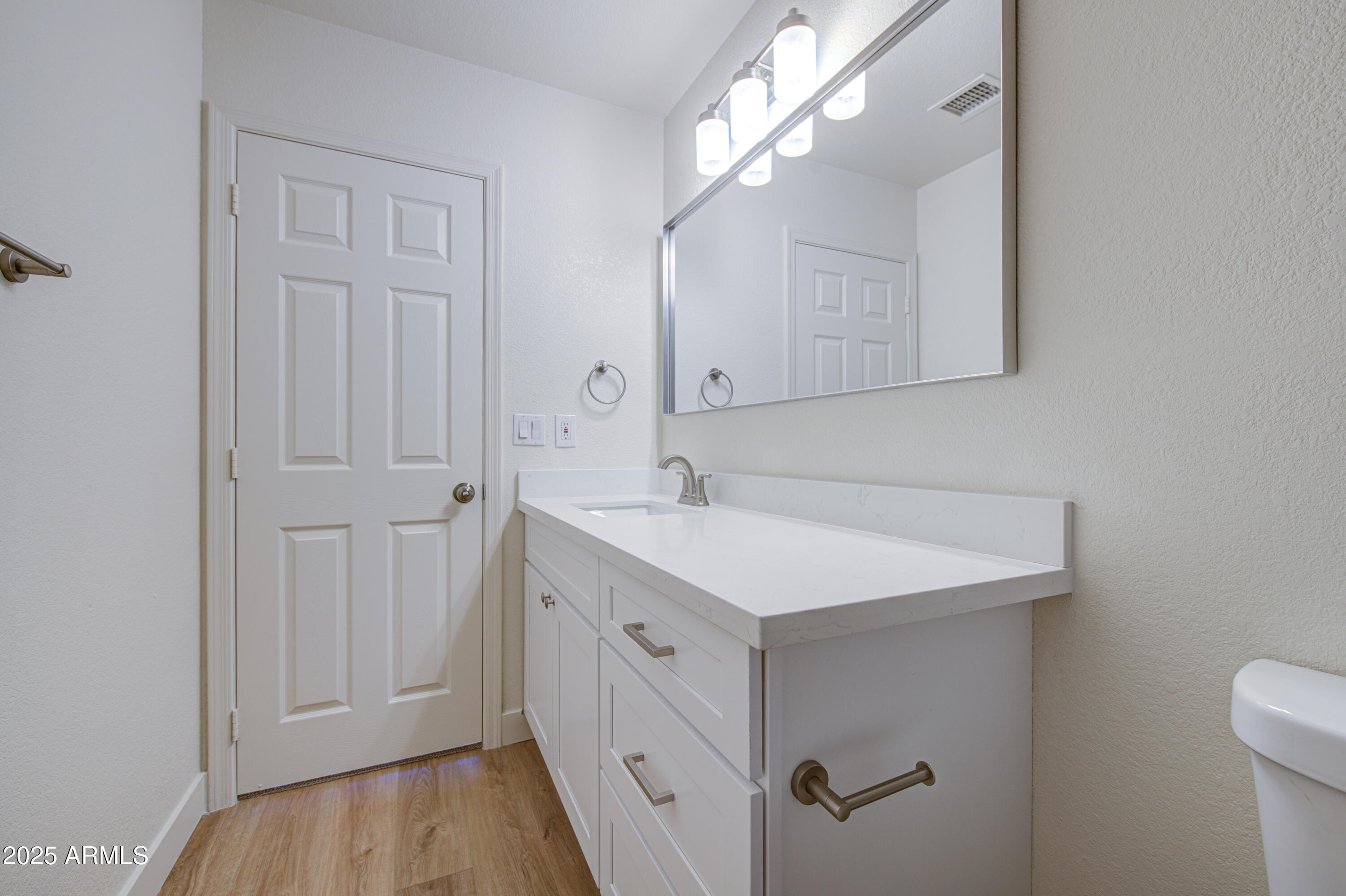 4266 East Millbrae Lane Gilbert, AZ 85234 - Photo 46 of 53 a bathroom with a sink a light fixture and a mirror