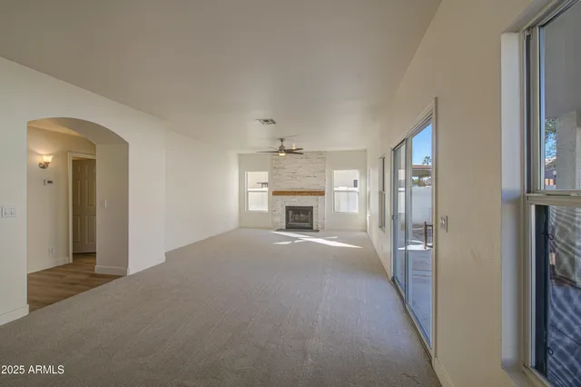 a view of an empty room and a fireplace
