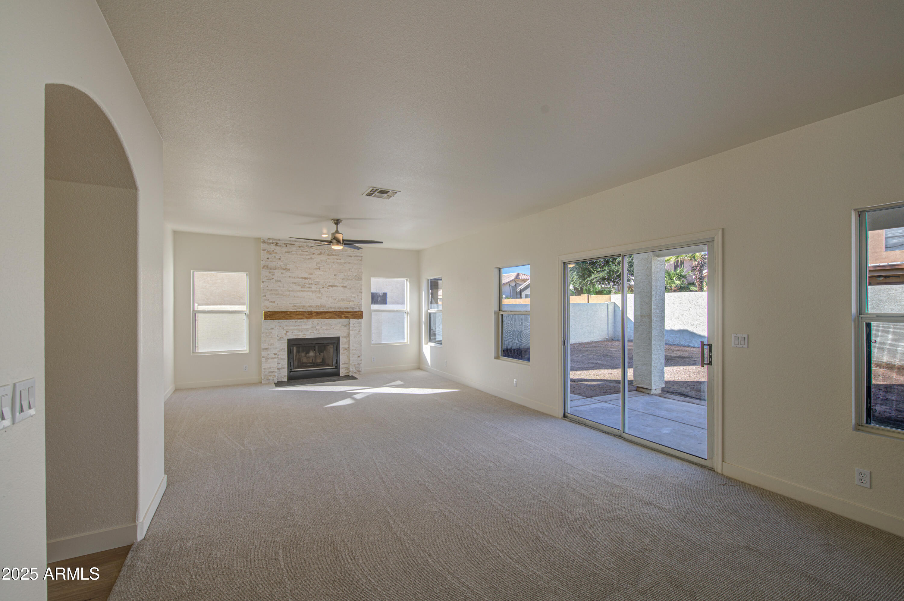 4266 East Millbrae Lane Gilbert, AZ 85234 - Photo 10 of 53 an empty room with windows and fireplace