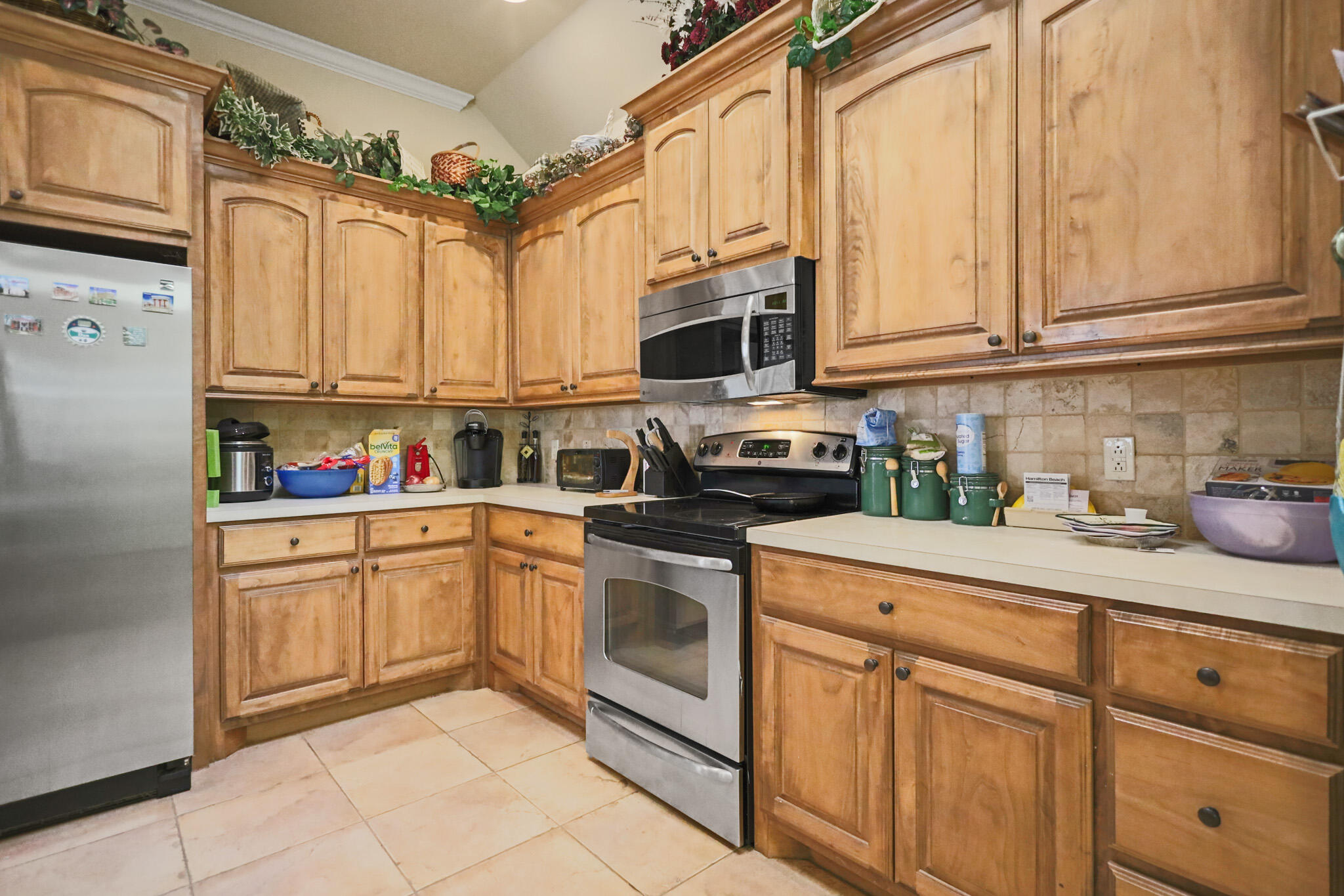 73 Windsor Court Lubbock, TX 79416 - Photo 13 of 34 a kitchen with stainless steel appliances granite countertop white cabinets a sink and dishwasher