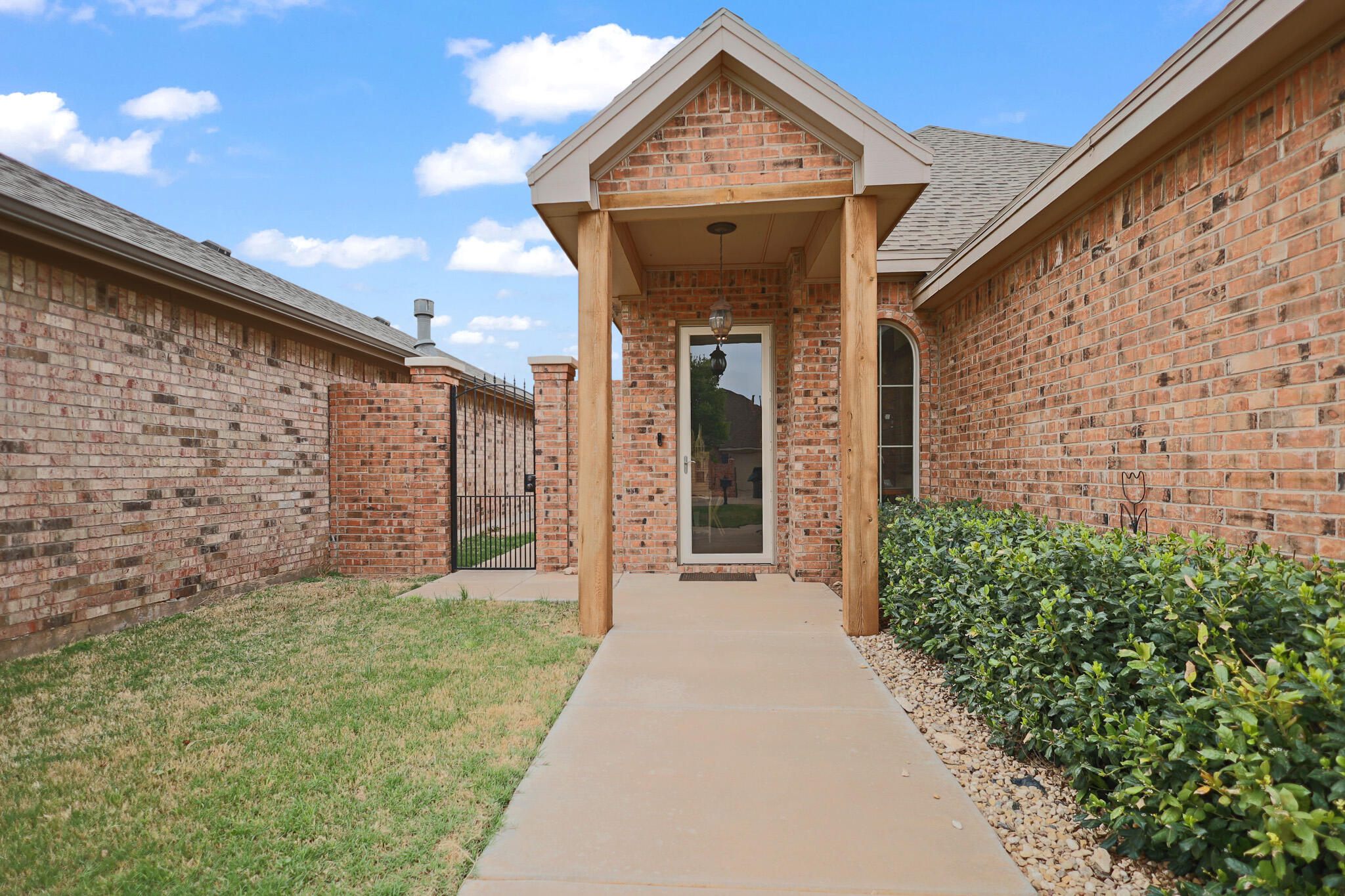 73 Windsor Court Lubbock, TX 79416 - Photo 2 of 34 a view of a brick house with potted plants