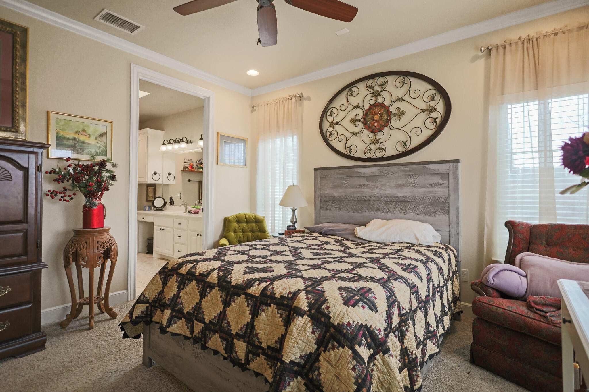 73 Windsor Court Lubbock, TX 79416 - Photo 21 of 34 a bedroom with a bed a couch and a chandelier