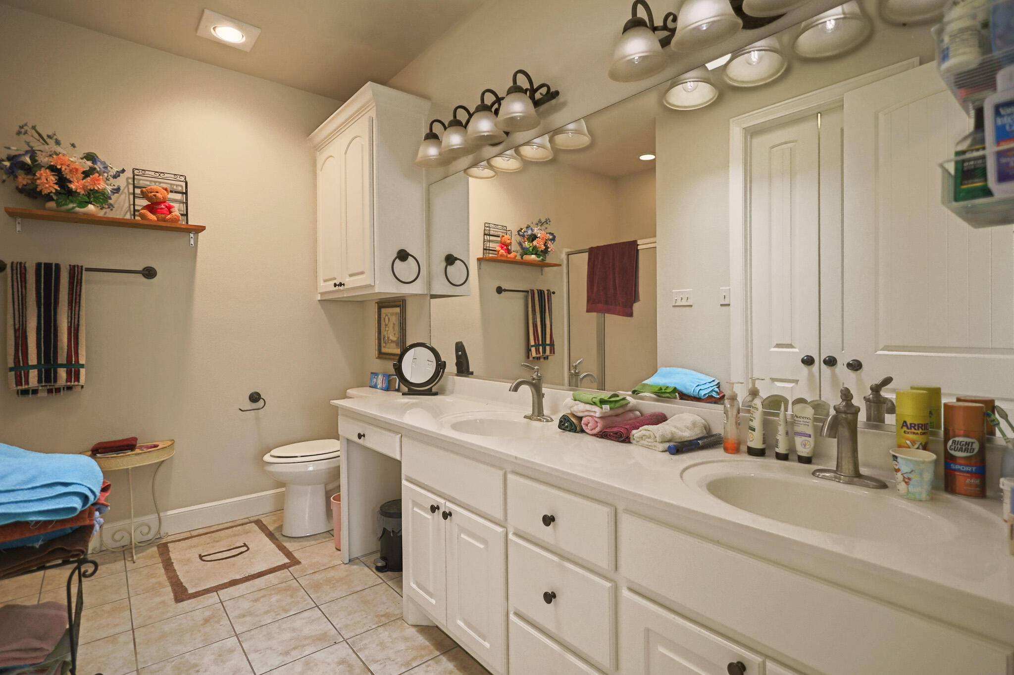 73 Windsor Court Lubbock, TX 79416 - Photo 22 of 34 a bathroom with a double vanity sink mirror and toilet