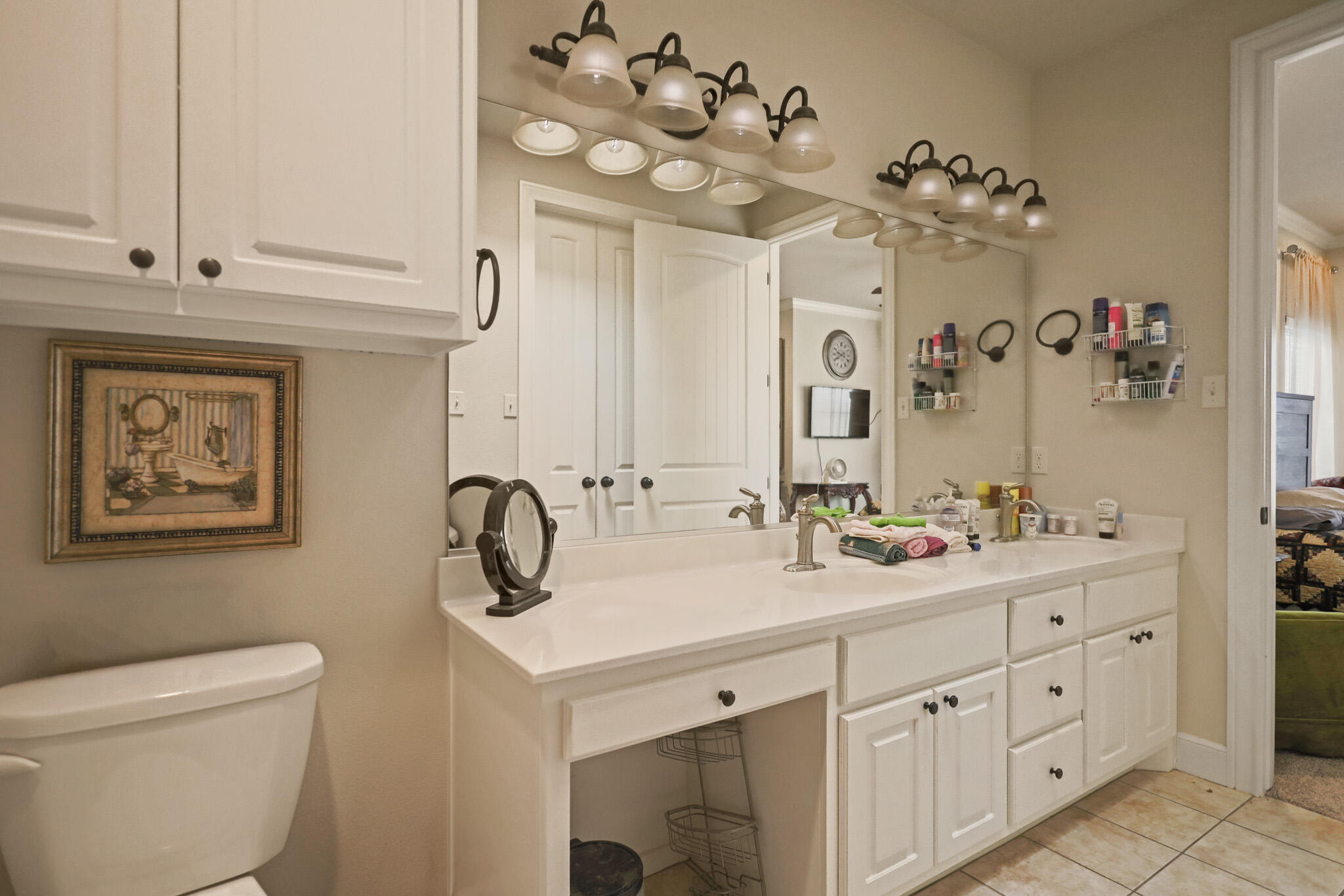73 Windsor Court Lubbock, TX 79416 - Photo 23 of 34 a bathroom with a double vanity sink mirror and toilet