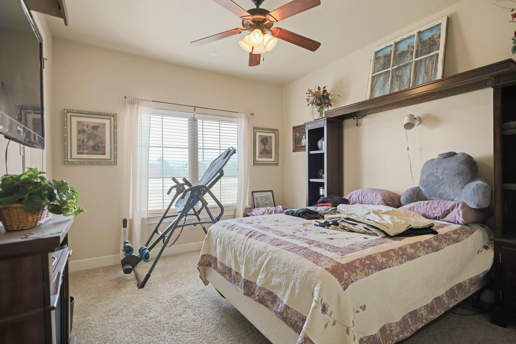 73 Windsor Court Lubbock, TX 79416 - Photo 25 of 34 a bedroom with a bed and gym equipment
