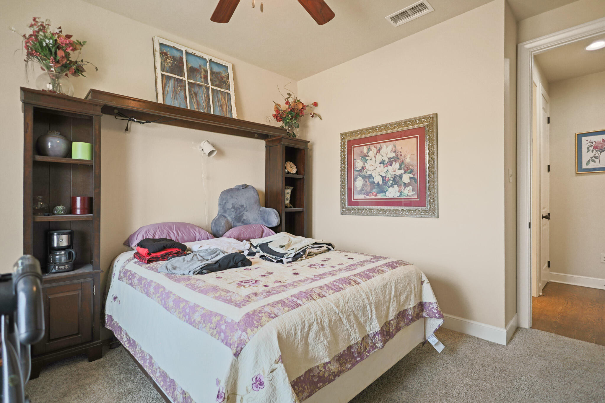 73 Windsor Court Lubbock, TX 79416 - Photo 26 of 34 a bedroom with a bed and a painting on the wall