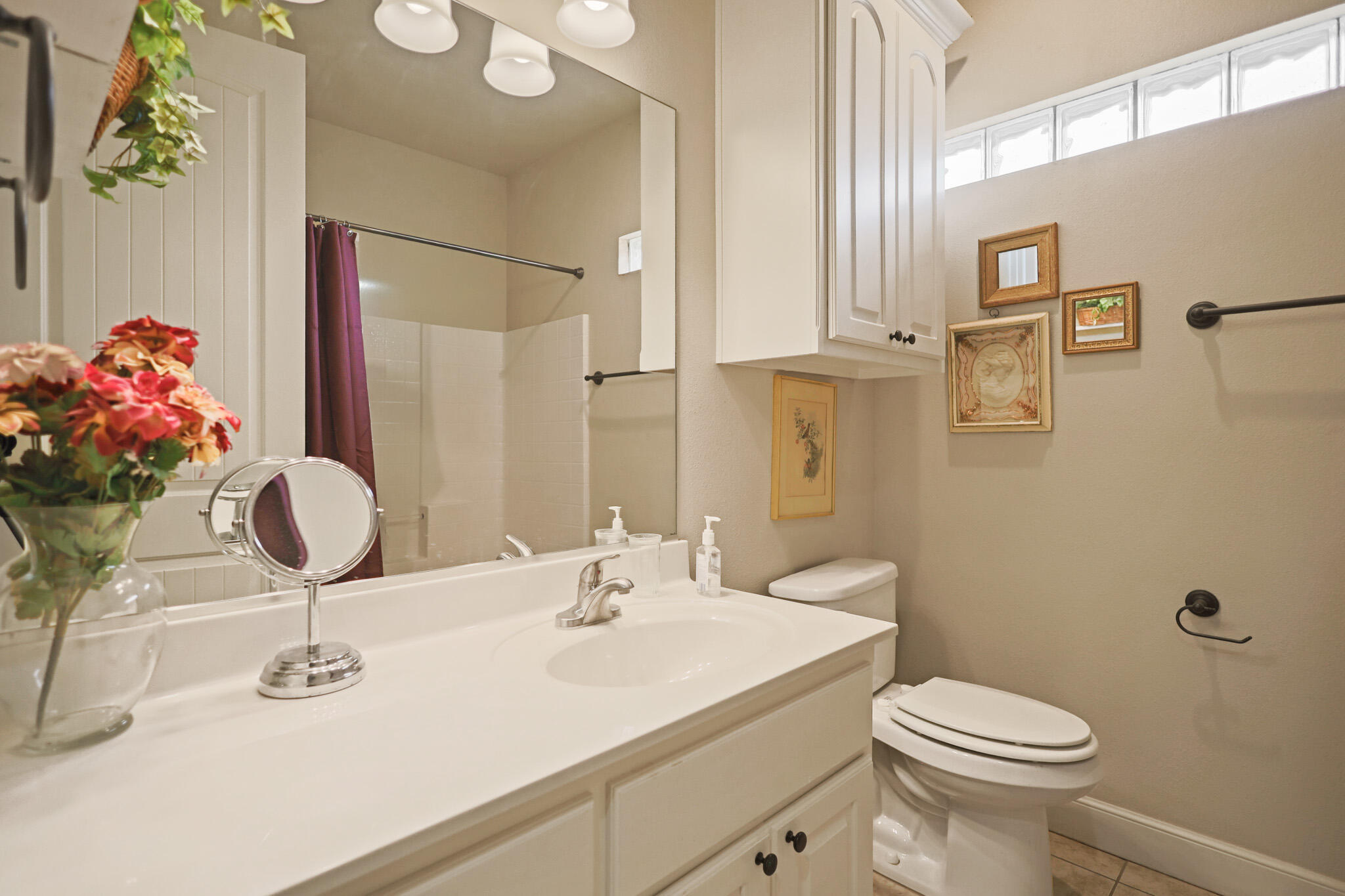 73 Windsor Court Lubbock, TX 79416 - Photo 27 of 34 a bathroom with a sink toilet and shower
