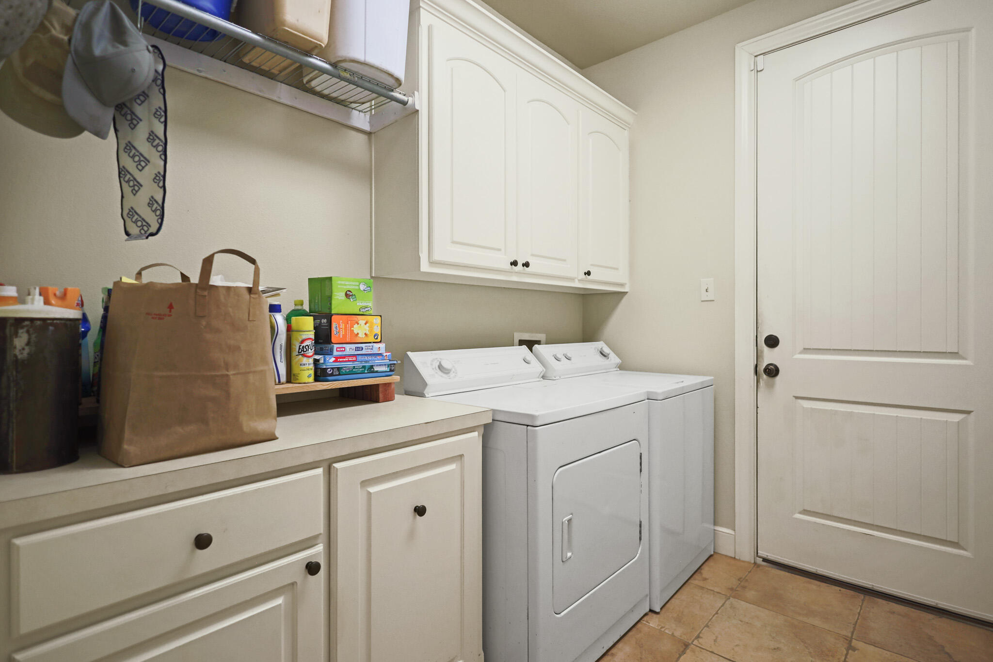73 Windsor Court Lubbock, TX 79416 - Photo 28 of 34 a utility room with cabinets washer and dryer