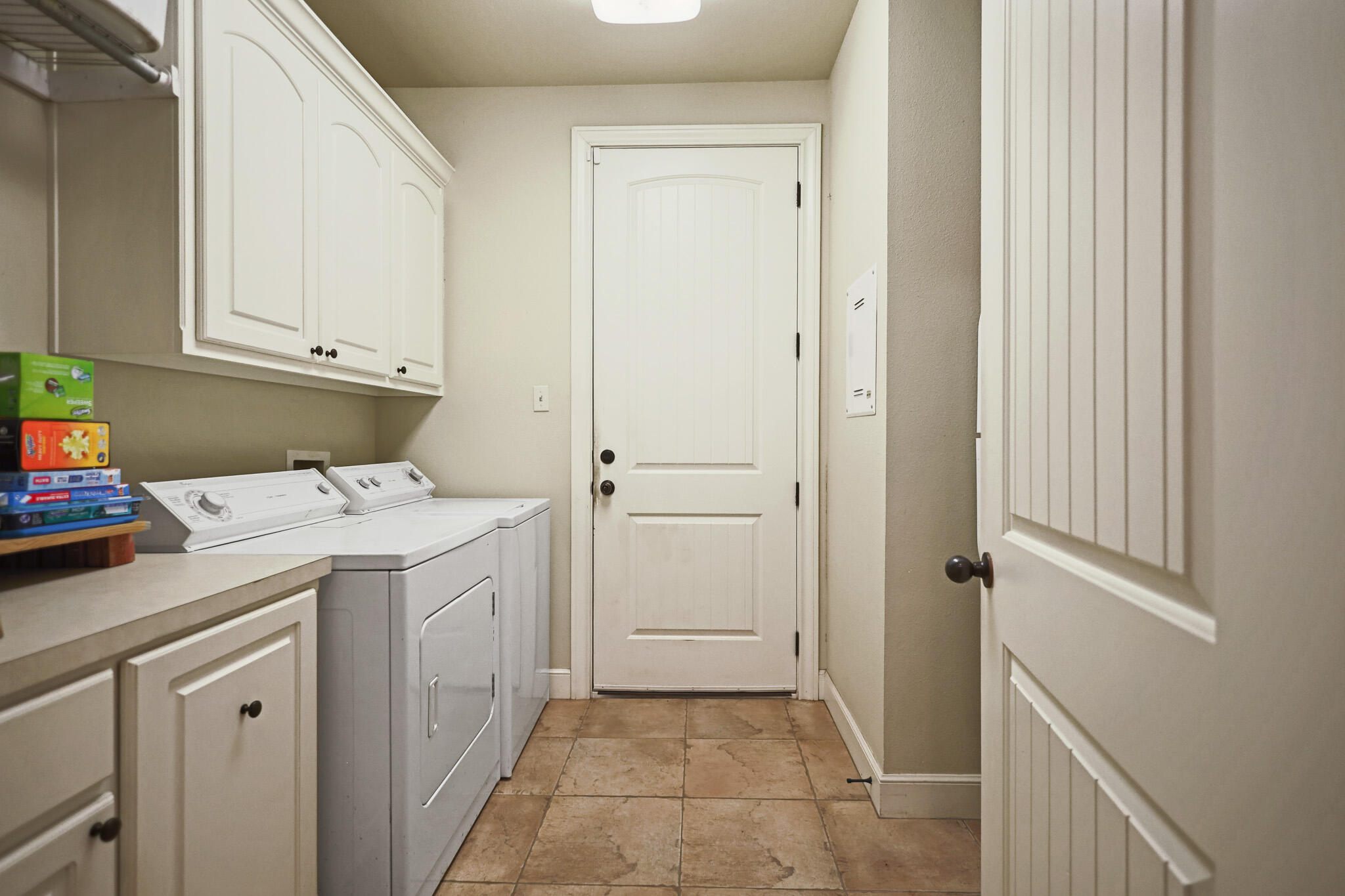 73 Windsor Court Lubbock, TX 79416 - Photo 29 of 34 a utility room with cabinets washer and dryer
