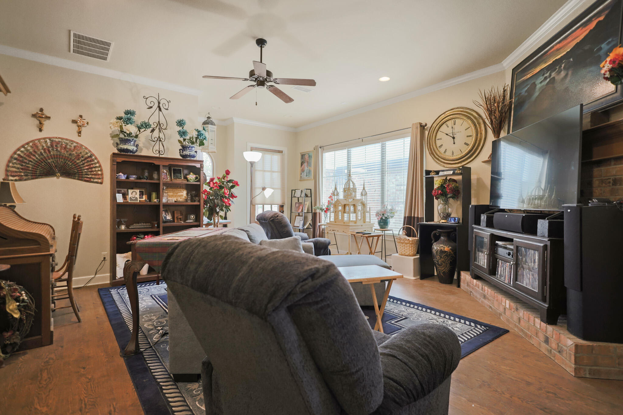 73 Windsor Court Lubbock, TX 79416 - Photo 5 of 34 a living room with furniture a clock and a chandelier