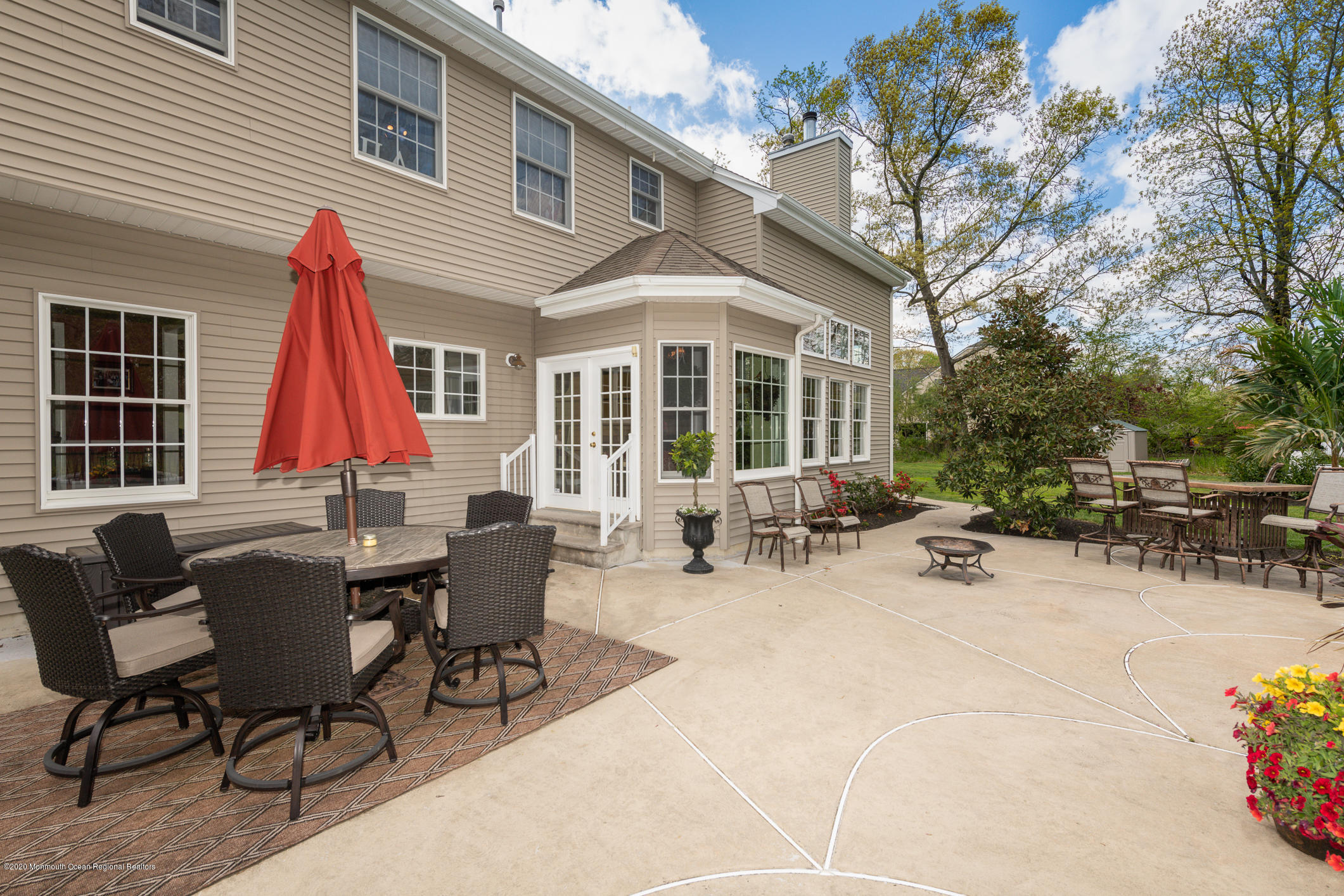 717 Fort Plains Road Howell, NJ 07731 - Photo 26 of 30 a view of a dinning table and chairs in the patio in front of a house
