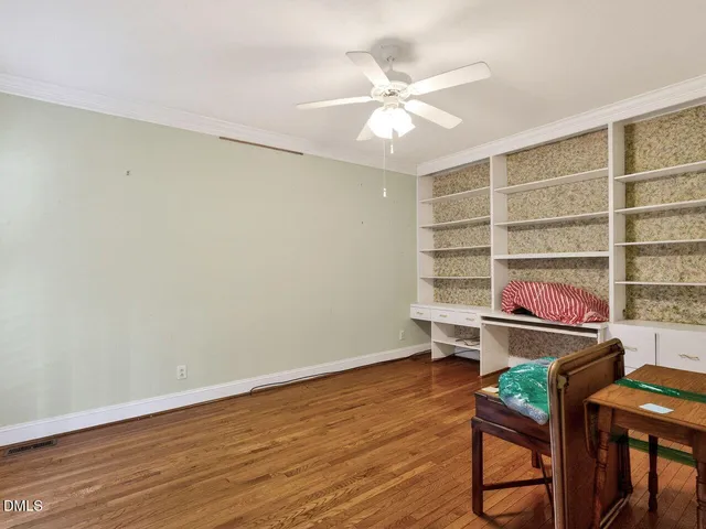 a view of a room with wooden floor and cabinet