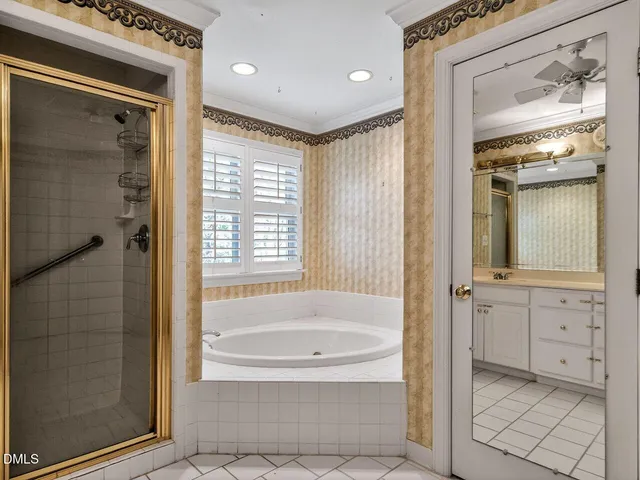 a bathroom with a granite countertop tub shower and mirror