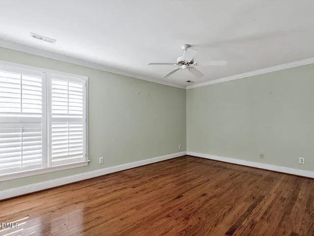 wooden floor in an empty room with a window