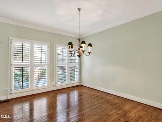 a view of a room with wooden floor and windows