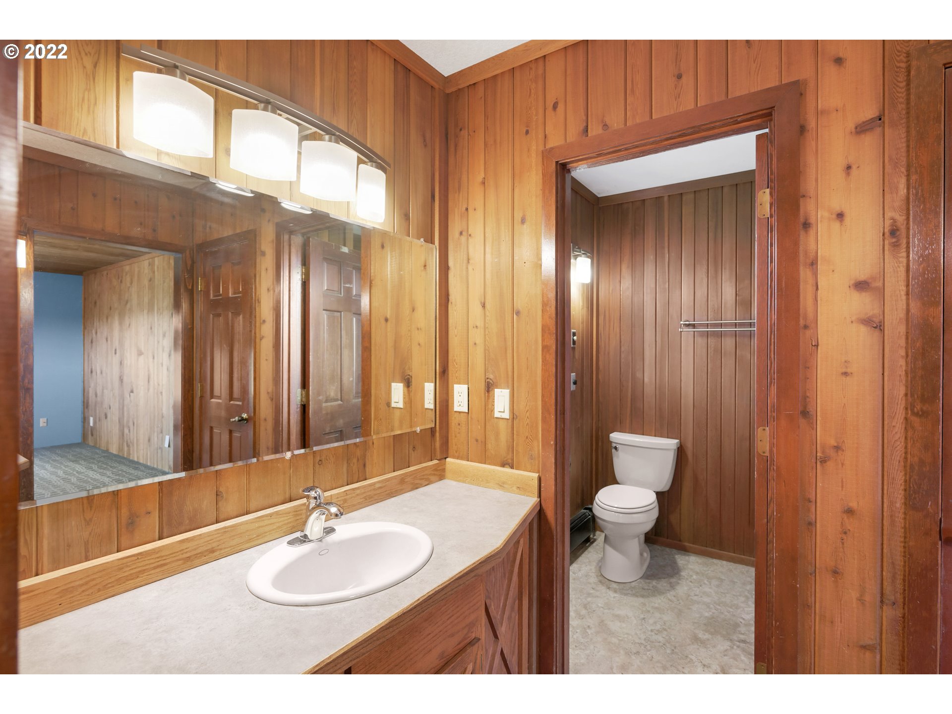 25861 South Larkin Road Beavercreek, OR 97004 - Photo 17 of 32 a bathroom with a sink a toilet and a mirror