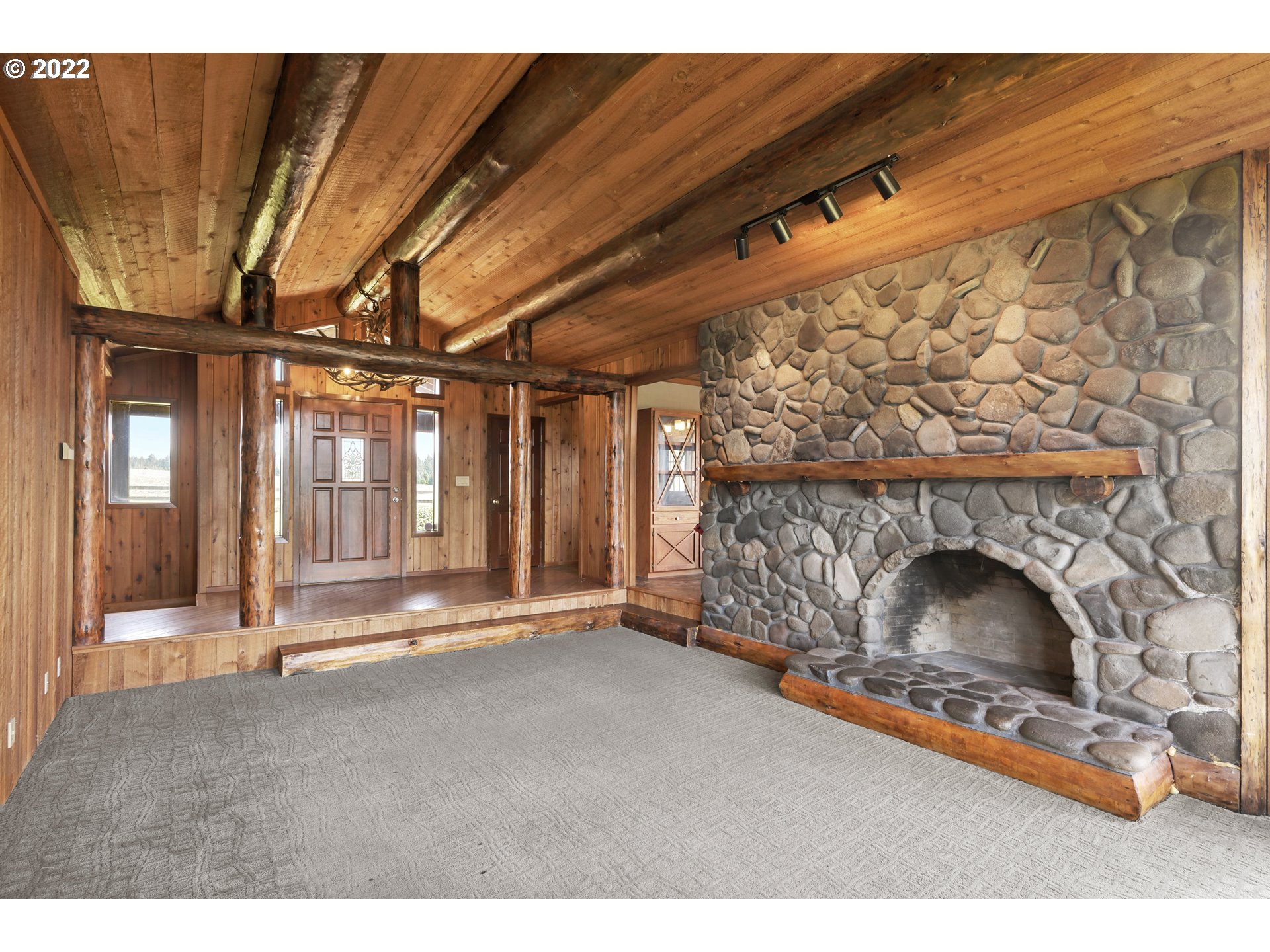 25861 South Larkin Road Beavercreek, OR 97004 - Photo 10 of 32 a view of an empty room with fireplace and a window