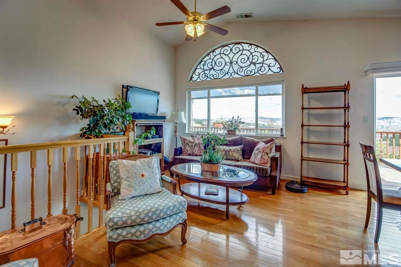 712 Talus Way Reno, NV 89503 - Photo 2 of 25 a living room with furniture a fireplace and a large window