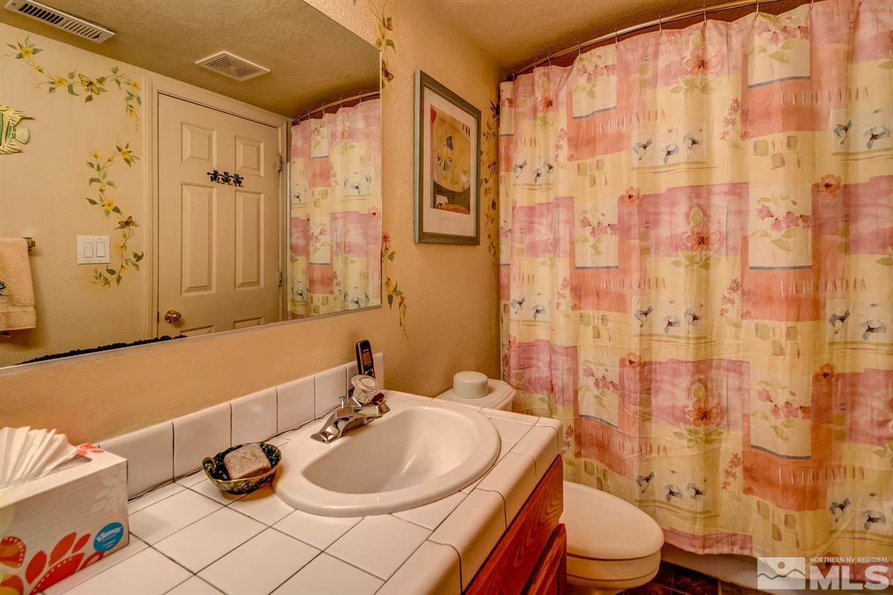 712 Talus Way Reno, NV 89503 - Photo 24 of 25 a bathroom with a sink a toilet and shower curtain