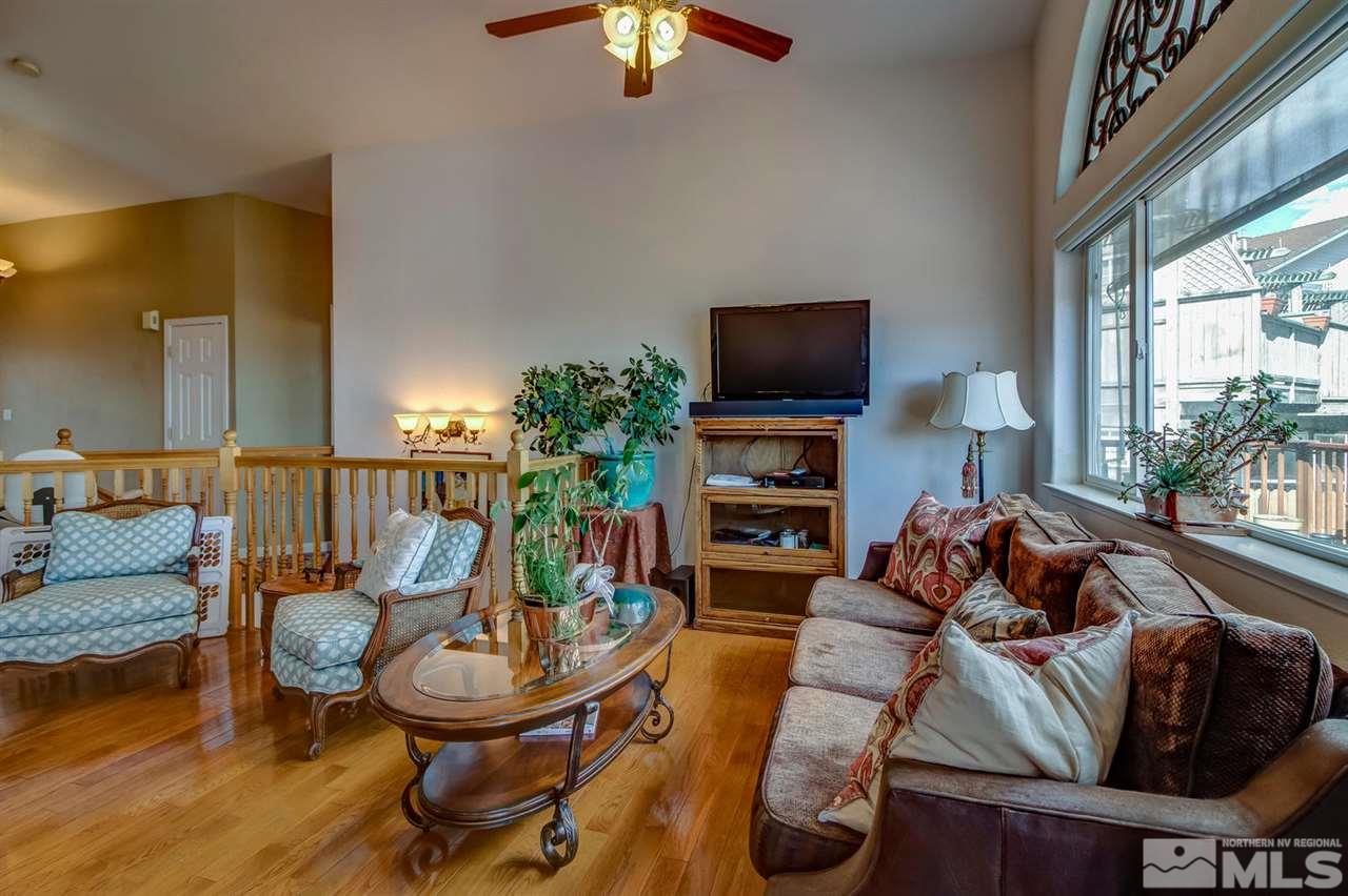 712 Talus Way Reno, NV 89503 - Photo 3 of 25 a living room with furniture a fireplace and a flat screen tv