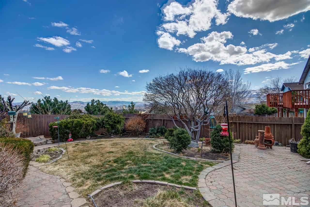 712 Talus Way Reno, NV 89503 - Photo 5 of 25 a view of a street with potted plants and large trees