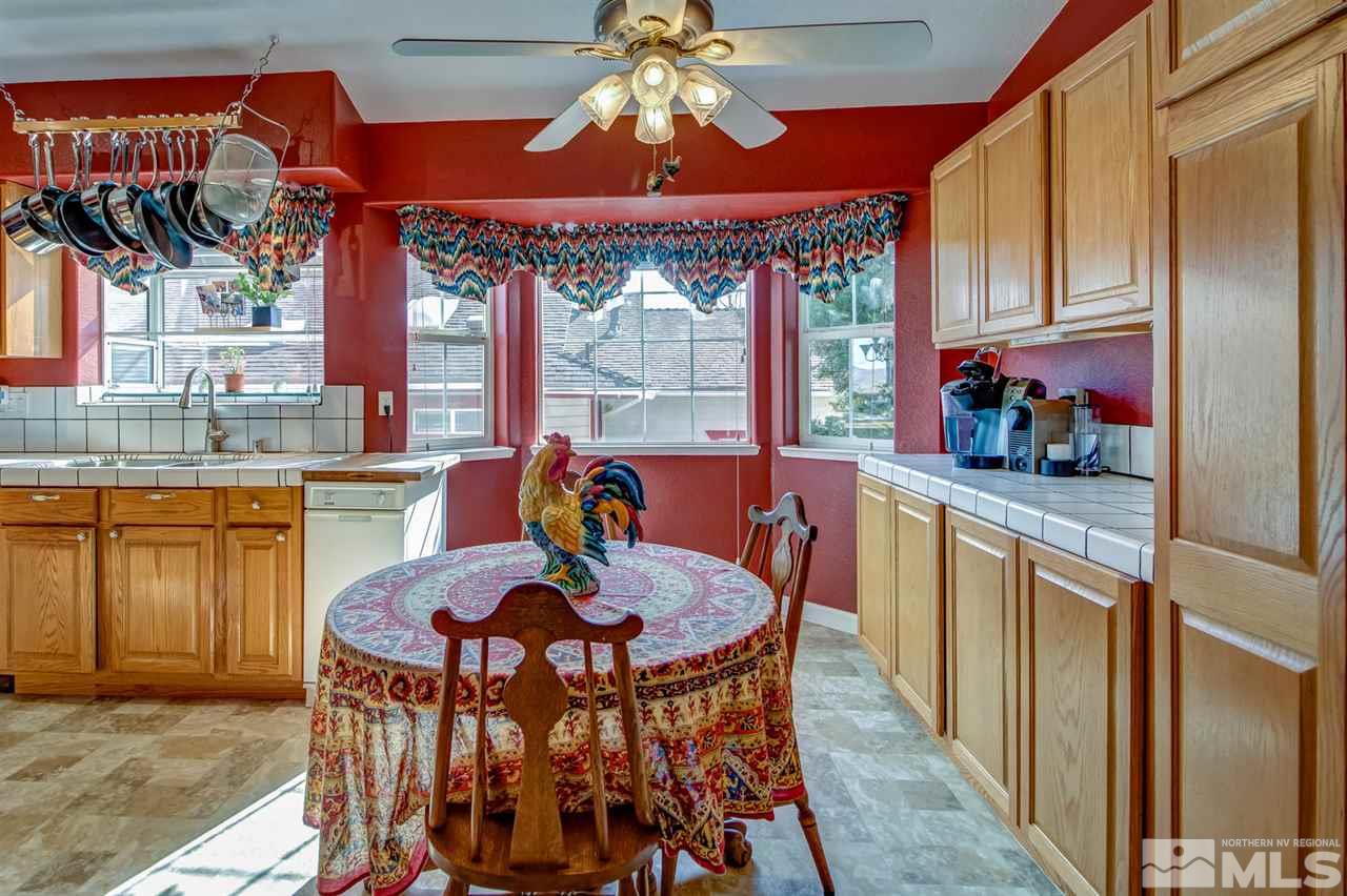 712 Talus Way Reno, NV 89503 - Photo 7 of 25 a view of a dining room with furniture a chandelier and large windows