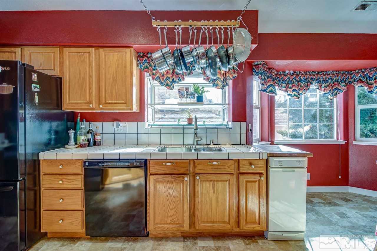712 Talus Way Reno, NV 89503 - Photo 9 of 25 a kitchen with stainless steel appliances granite countertop a stove a sink and a microwave