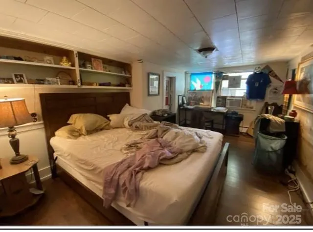 a bed sitting in a bedroom next to a window