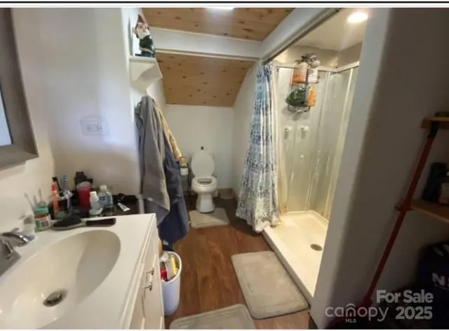 a bathroom with a sink and mirror with bathtub